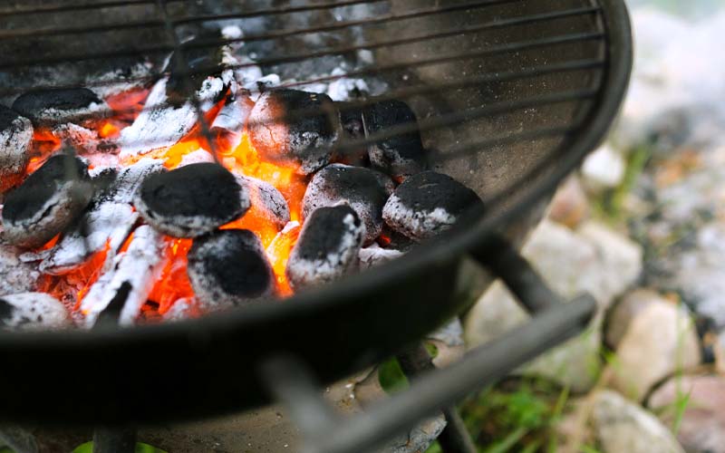 Gros plan sur les braises d'un barbecue au camping à Messanges