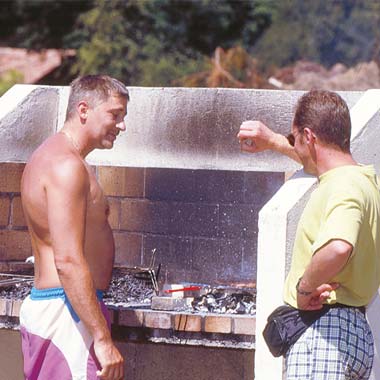 Two campers having a barbecue at the campsite in the Landes near Vieux-Boucau