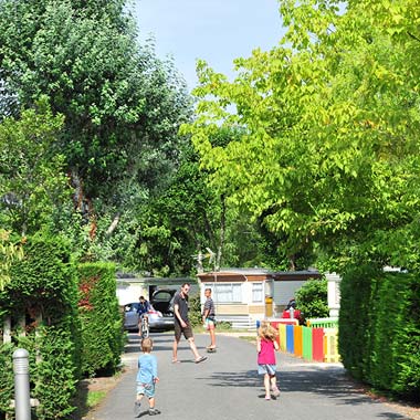 Children on an alley of the campsite with mobile home rental in the Landes